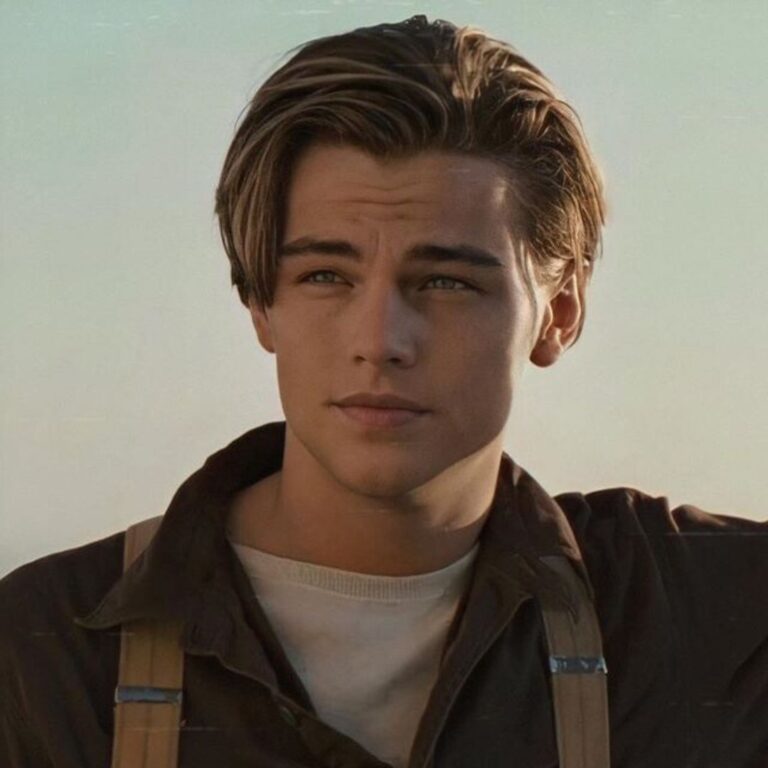 Leonardo DiCaprio during his unforgettable role as Jack Dawson in the movie "Titanic," captured here in a scene, showcasing his dashing charm with a sleek and impeccably slicked-back hairstyle.