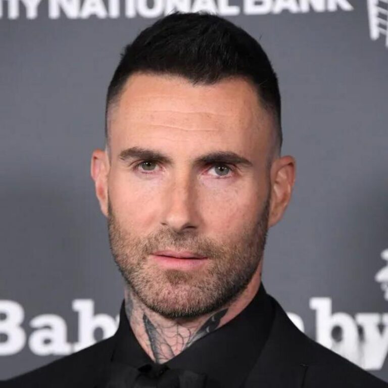 Adam Levine at a prestigious music award premiere, stealing the spotlight with his dashing short and textured crop hairstyle, epitomizing modern elegance and effortless charm.