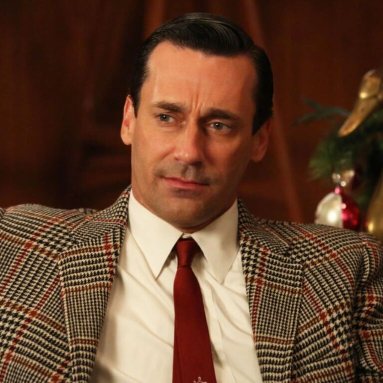In a captivating movie scene from "Mad Men," Jon Hamm embodies the character with suave sophistication, clad in a sleek suit and sporting his iconic slicked-back hairstyle.