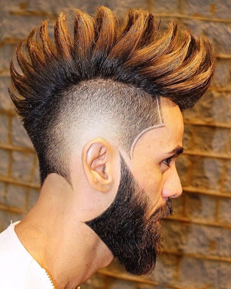 An Arab man with a dyed spiky mohawk haircut.