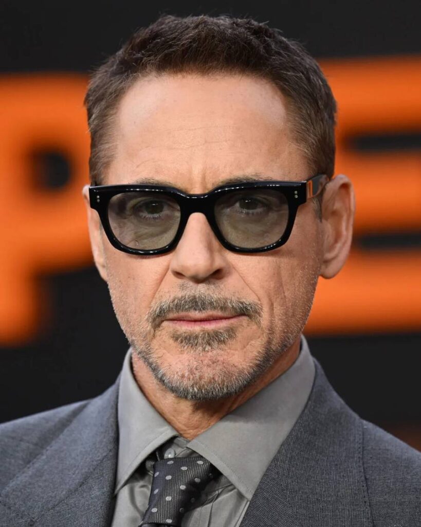 Robert Downey Jr. showcasing a stylish haircut, epitomizing charm and handsomeness in a captivating portrait.