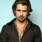 A man with long hair wearing a black shirt, showcasing a stylish haircut.